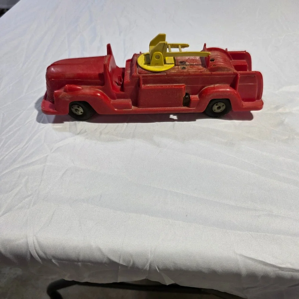 Vintage Red Plastic Fire Truck Toy with Rotating Yellow Ladder and Hose Reel